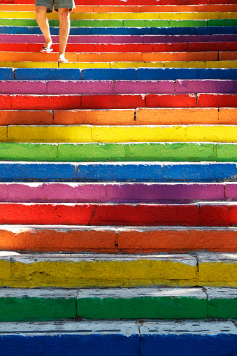 a man is descending a very colourful staircase