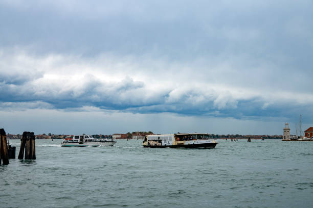 This is a wide angle image taken from the Gondola stations at San Marco Square in Venice, Italy. It shows vaporetto water buses in the Lagoon in front of San Giorgio Maggiore.