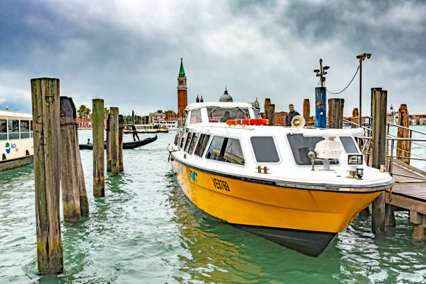 This is a wide angle image taken from the Gondola stations at San Marco Square in Venice, Italy. It shows vaporetto water buses in the Lagoon in front of San Giorgio Maggiore.
