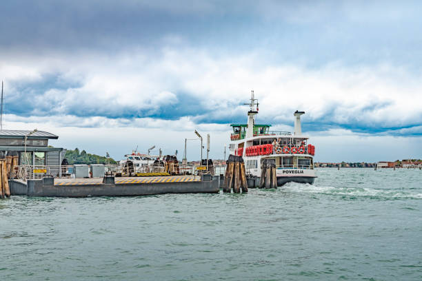 This is a wide angle image taken from the Gondola stations at San Marco Square in Venice, Italy. It shows vaporetto water buses in the Lagoon in front of San Giorgio Maggiore.