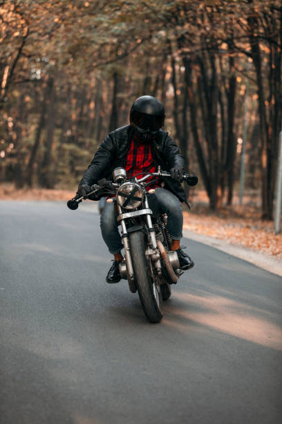 istock Biker with vintage motorcycle on the road 1186347581