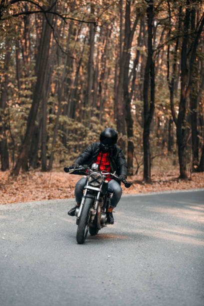istock Biker with vintage motorcycle on the road 1186347589