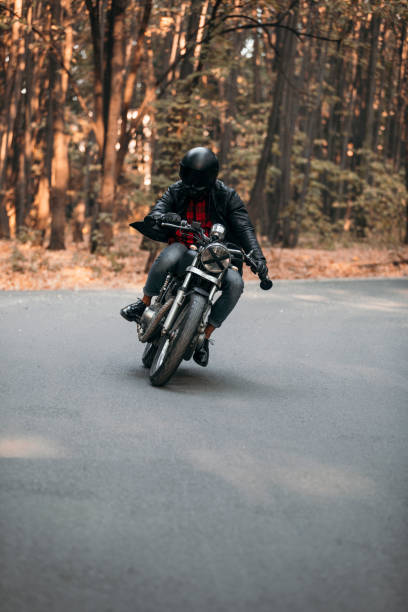 istock Biker with vintage motorcycle on the road 1186348161