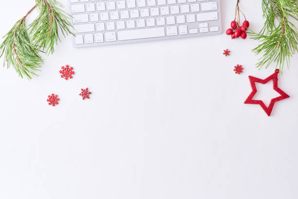 istock Flat lay christmas home office desk with pine branches and keyboard, christmas decorations  on a white background 1186348292