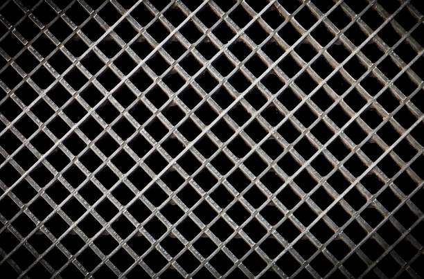 istock Iron ventilation grid lattice texture background. Silver gray metal pattern with square holes on black. 1186351769