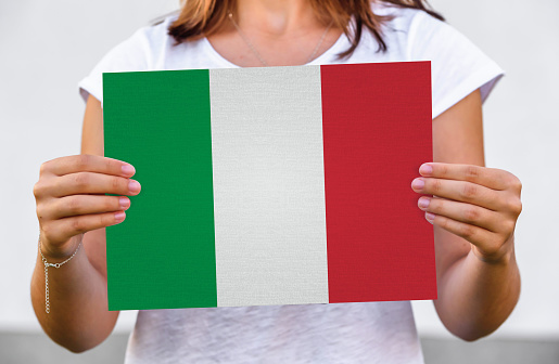 woman holds flag of Italy on paper sheet