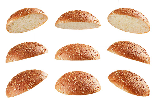 Burger bread tops levitating in different angles on white background; full depth of field