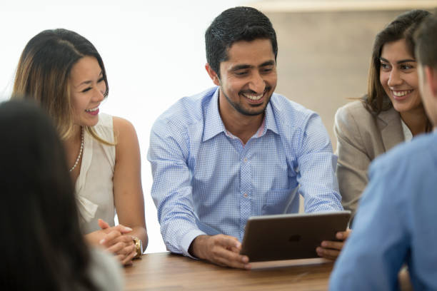 istock Boardroom Meeting Around a Digital Tablet stock photo 1186354533