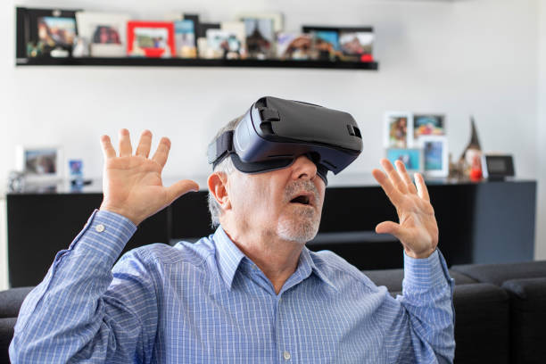istock Elderly man surprised when he plays with virtual reality goggles 1186354541