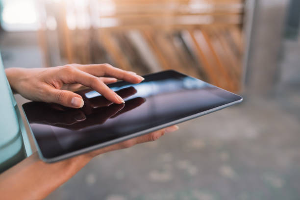 istock Businesswoman standing in an office working on a digital tablet 1186355298