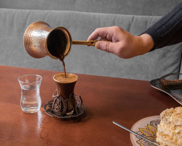 istock strong aromatic turkish coffee is poured from turk in a beautiful glass. 1186358239