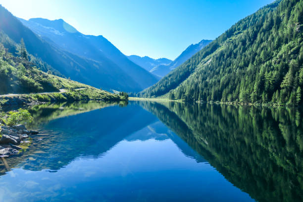 istock Schladming - Lake reflecting the mountains 1186358397