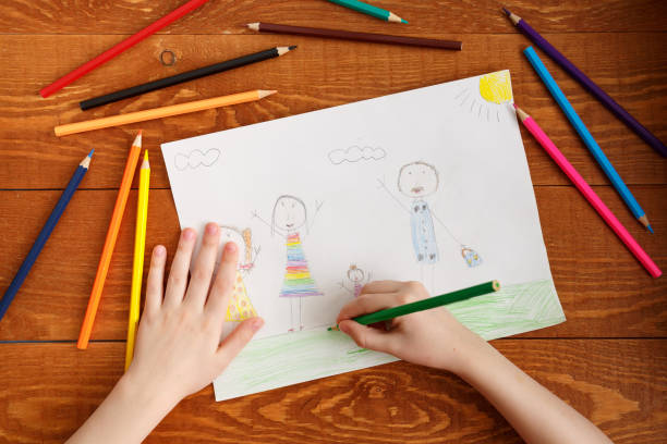 istock Character Child Drawing Image on Wooden Table 1186359638