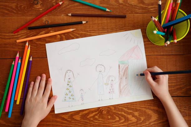 istock Character Child Drawing Image on Wooden Table 1186359640