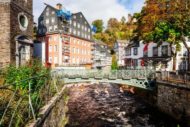 Monschau old city with half timbered houses and river, Germany. Beautiful autumn sunny landscape. Famous place and travel destination