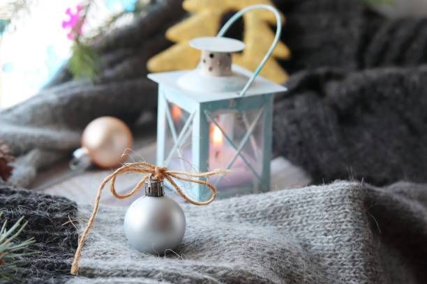 istock Christmas decor, spruce branch, balls, woolen plaid, lantern with a burning candle 1186361482