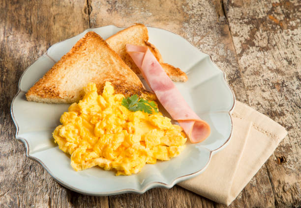 istock Scrambled eggs with crusty bread and bacon - Delicious breakfast 1186361530