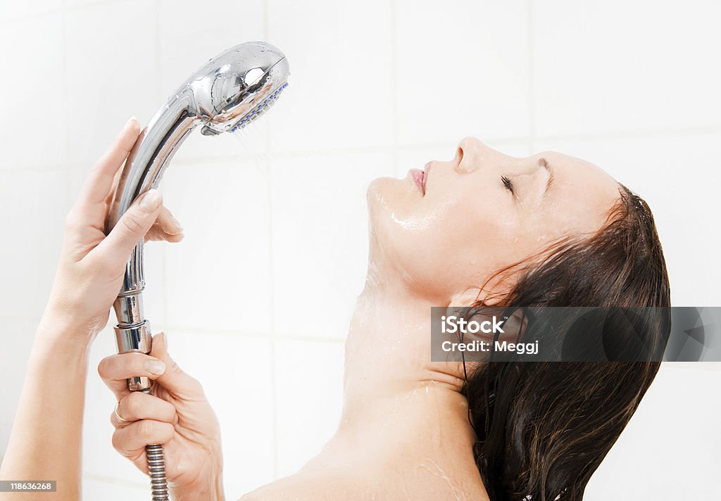 Young smiling woman taking a shower  Adult Stock Photo