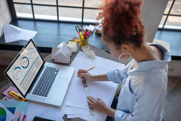 istock Top view of woman using ruler while making sketches 1186364174