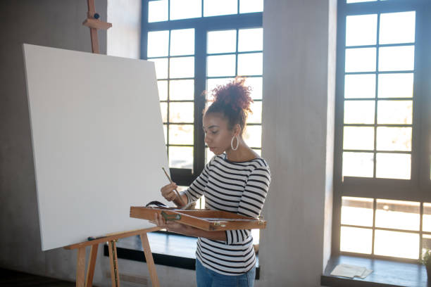 istock Artist choosing painting brush while starting working 1186364191