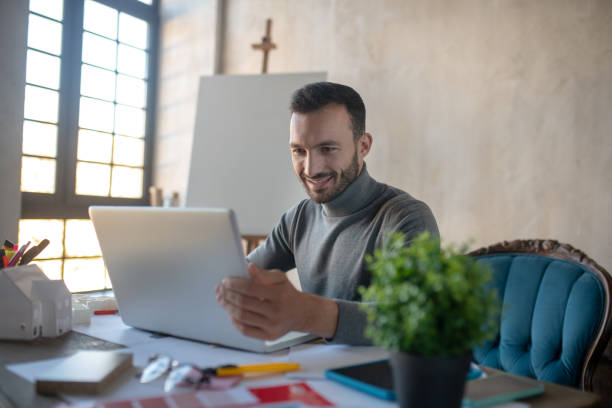 istock Handsome businessman working on laptop at the weekend 1186364269