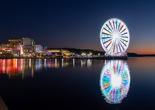 National Harbor, Maryland - 6 November 2019: Illuminated Capital Wheel ferris ride at National Harbor near Washington DC at sunset