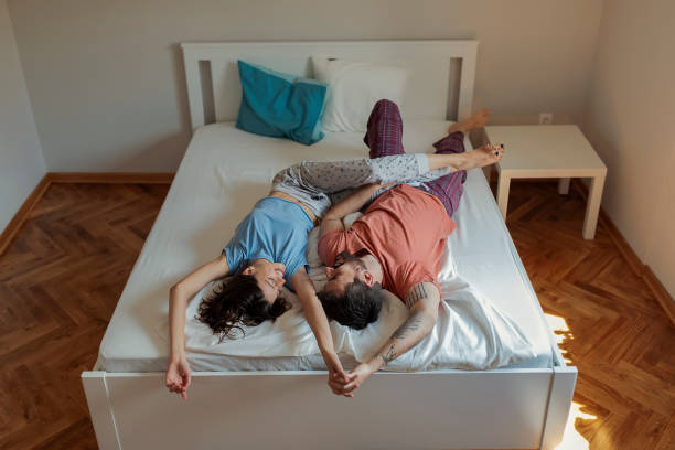 istock Happy Young Couple in Bed 1186368979
