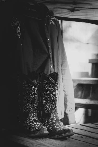 istock Cowboy boots on steps next to western shirt 1186370070