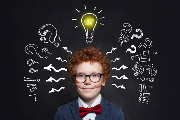 istock Little boyin glasses with lightbulb. Brainstorming and idea concept 1186370330