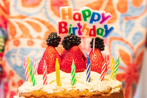 First Birthday cake close up photo. Strawberry layer cake, juicy berries on a table. Sweet food photo.