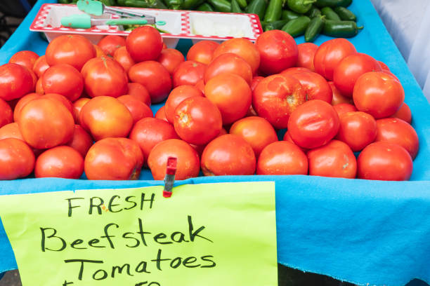 Fresh beefsteak tomatoes for sale at a farmers market