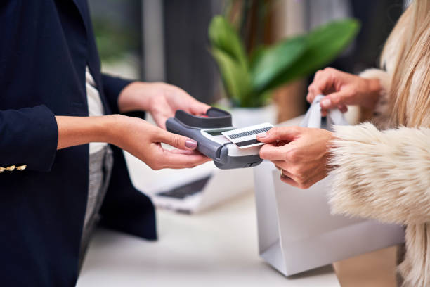 istock Shop assistant serving the customer in store 1186372442
