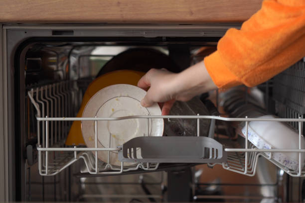 dirty dishes in the dishwasher - water human hand stream clean imagens e fotografias de stock