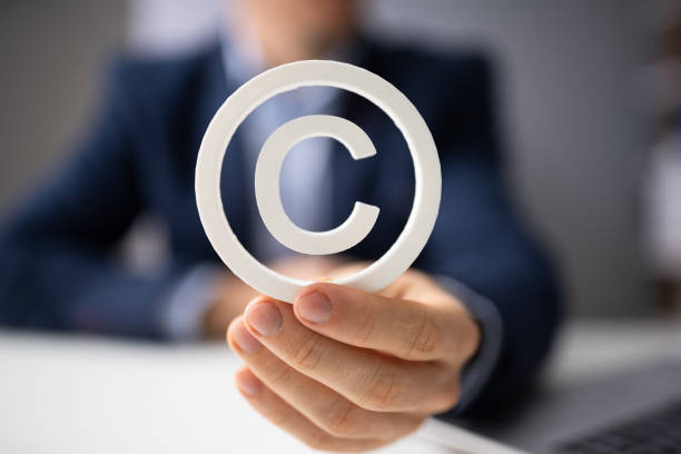 Person Holding White Copyright Sign Person Holding White Copyright Sign In Hand patent stock pictures, royalty-free photos & images