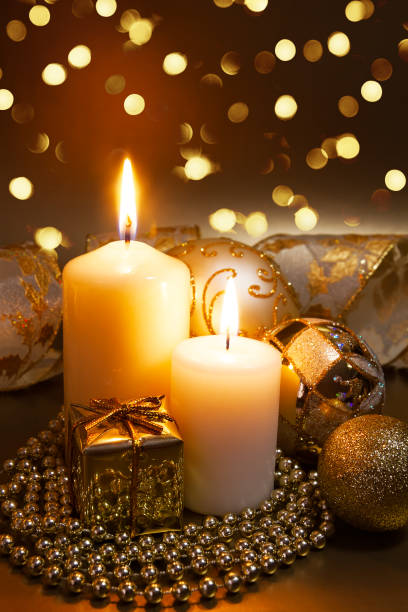 istock Christmas ornaments over dark golden background with lights. 1186376836