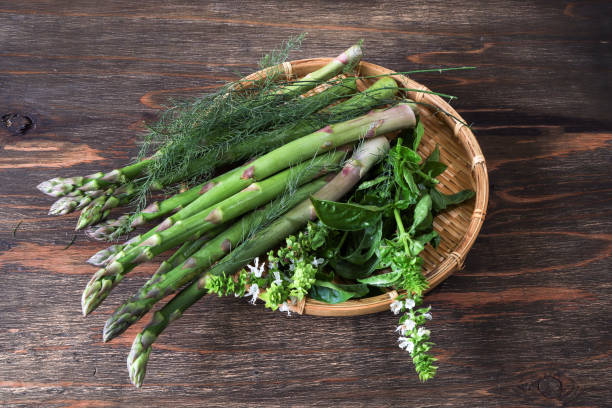 istock Asparagus and basil on the bamboo colander 1186380115