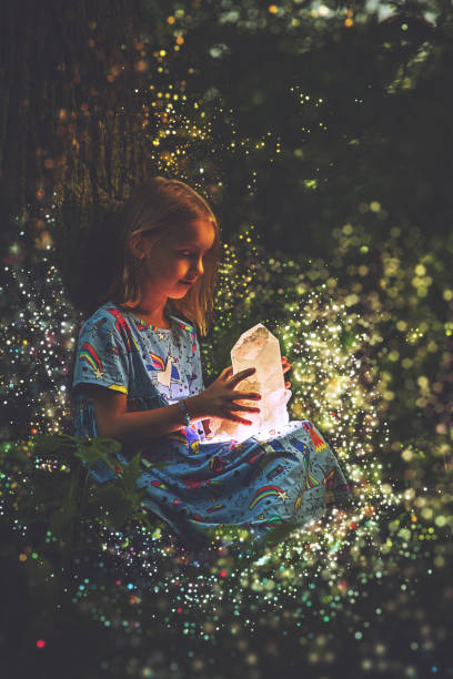 istock Little girl holding glowing crystal 1186381710