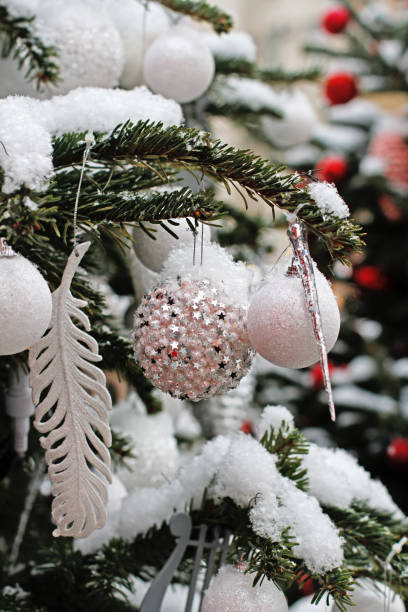 istock Christmas white balls, feather and icicle hanging on the Christmas tree 1186382954