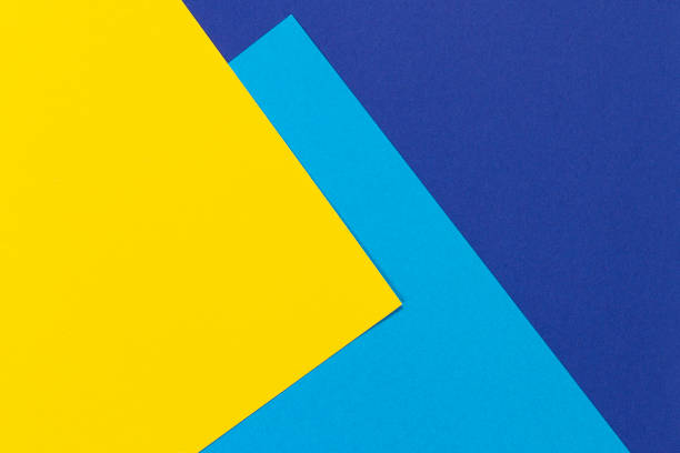 istock Creative abstract blue and yellow color geometric paper compositon background, top view 1186387650