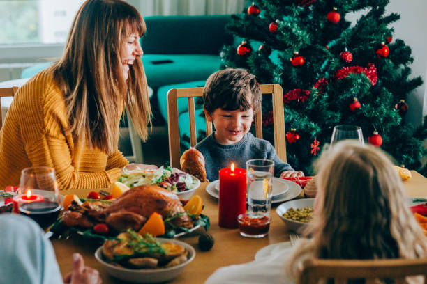 istock Happy mother and her son having fun while biting turkey leg 1186389211