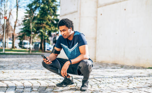 istock Young athlete with smart phone 1186389314