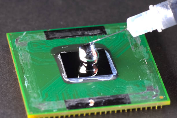 istock Application of liquid metal to processor to install a cooling system. 1186394269