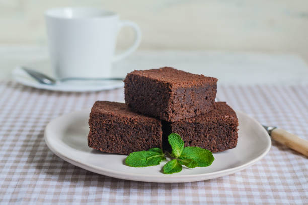 istock chocolate brownie pieces decorated with mint  on a white plate 1186395354
