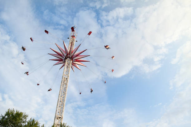 istock people swinging on big swing at amusement park 1186395593