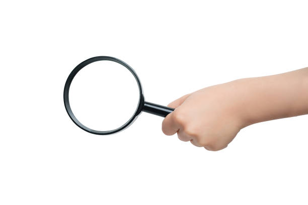 Hand with magnifying glass isolated on white background