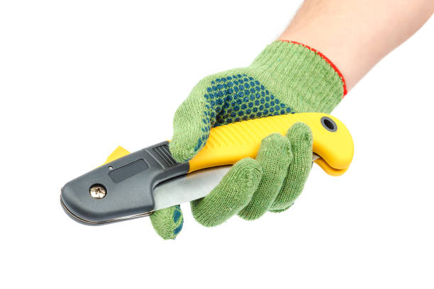istock Folding garden saw in hand with glove 1186397675