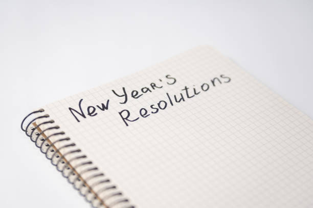 istock Phrase New Year's Resolutions in the notebook. Close-up 1186399696