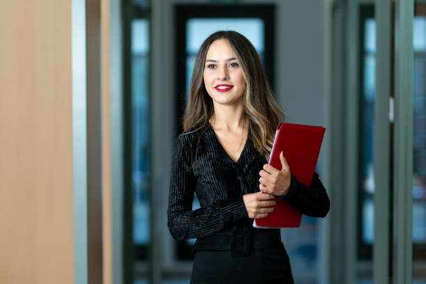 istock A beautiful woman ready for a team meeting with her red file. 1186400959