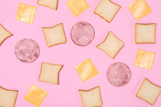 istock Toast bread ham and cheese pattern isolated on pink top view 1186401811
