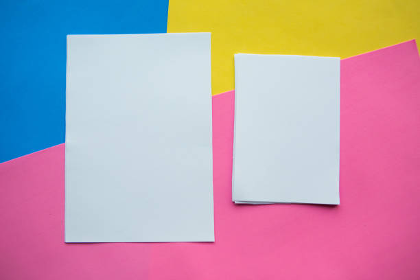 istock white mockup blanks on geometric blue, yellow and pink paper background 1186408970